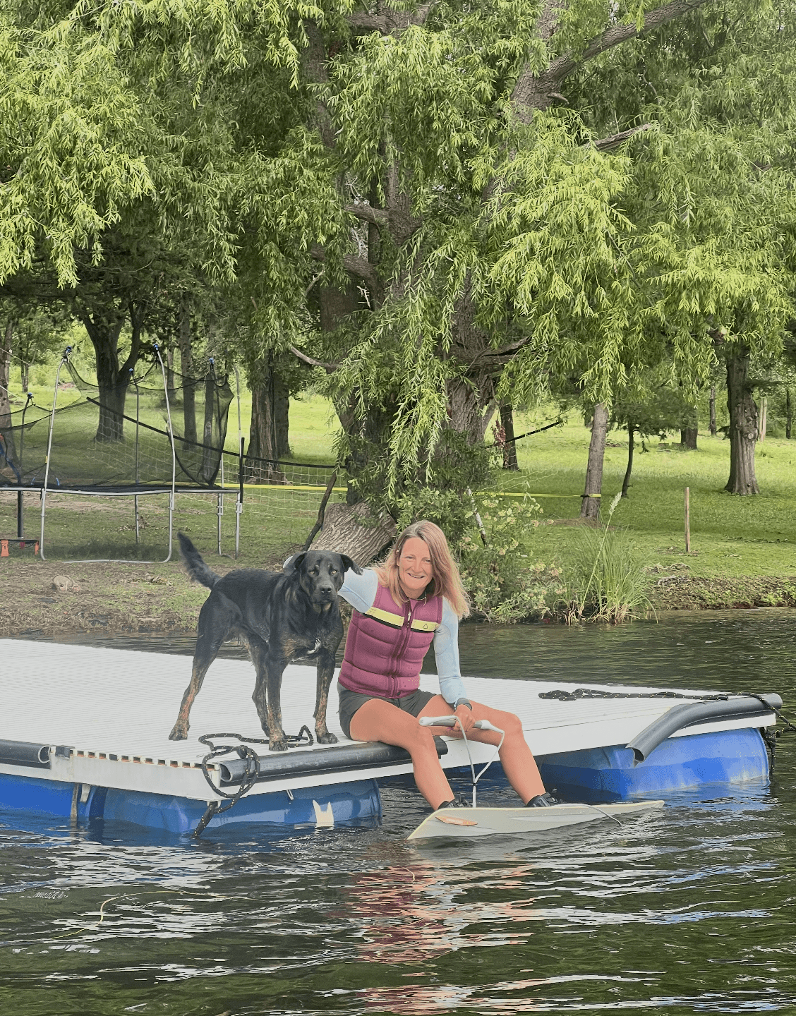 Rider getting ready on the floating dock with the club dog